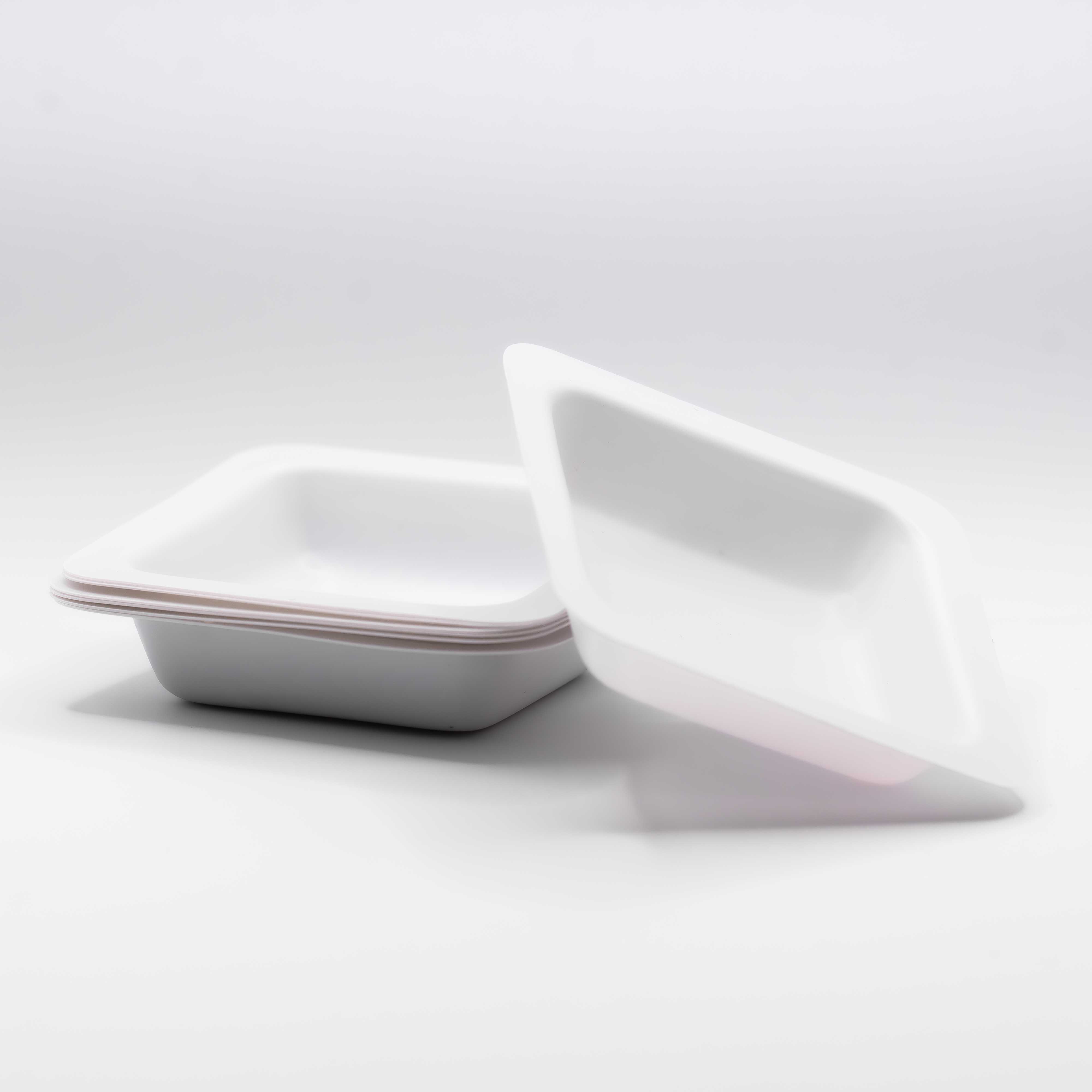 A small pile of disposable containers on a white background