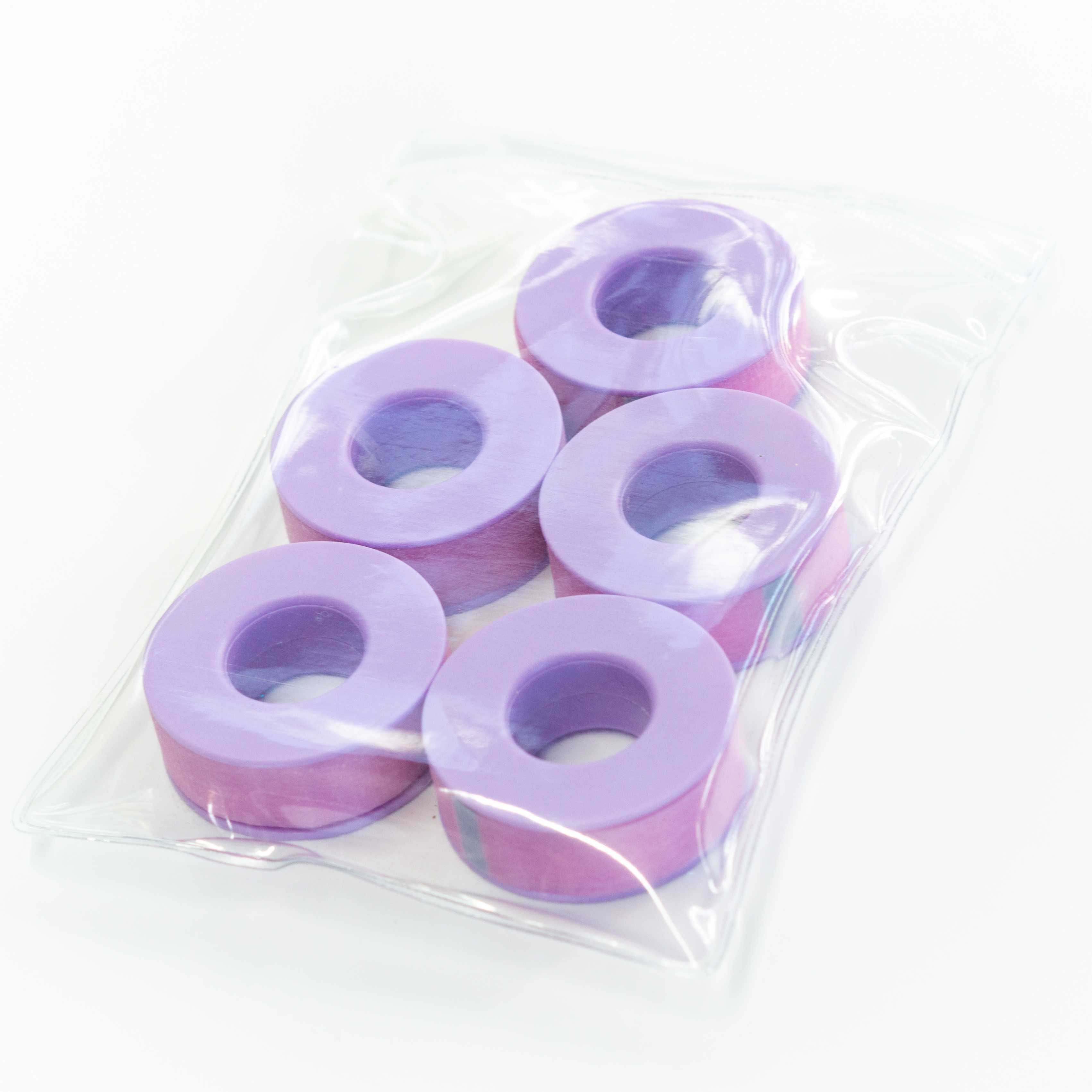 Five purple tape rolls in a plastic bag.